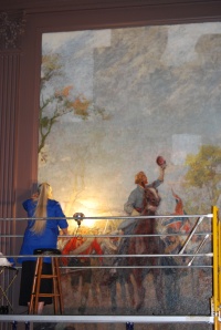 Cleo Mullins, lead conservator, cleaning the "Spring" mural. Credit: Virginia Historical Society